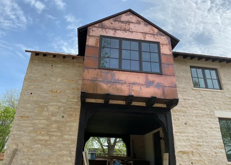 Copper metal panel facade on a stone building for Metal Roof Coating in Citrus Hills